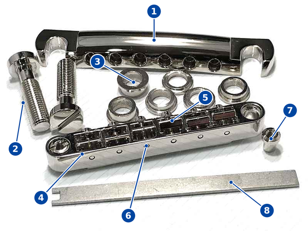 Labeled Faber replacement parts for an Epiphone: stop tailpiece, Tone-Lock studs, spacers, bridge, saddles, lock nut and tool